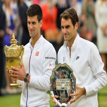 Novak Djokovic (left) and Roger Federer (right) lift the champion and runner