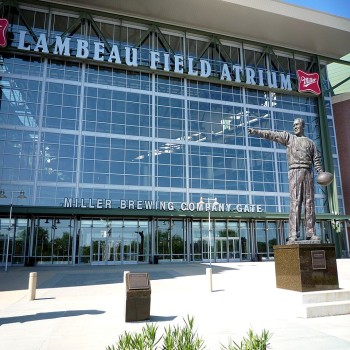 A statue of Curly Lambeau stands near the main entrance.