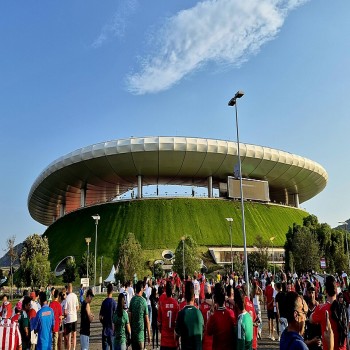 The exterior of the stadium showing the distinctive grass berm.