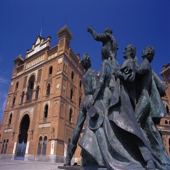 View of the Neo-Mudéjar façade and a neighbouring sculpture by Luis Sanguino.
