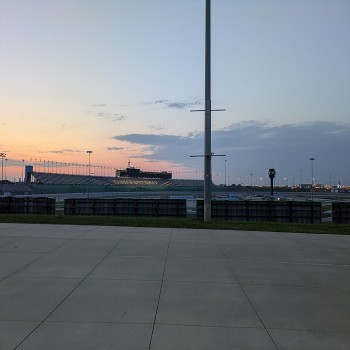 Kansas Speedway stands and track at dusk in August 2025