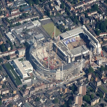 Aerial view of White Hart Lane, partially demolished, with new stadium under construction next to it.