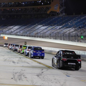 NASCAR cars on pit road during a nighttime qualifying session in 2015. In 2005, the facility installed lights to accommodate racing at nighttime.